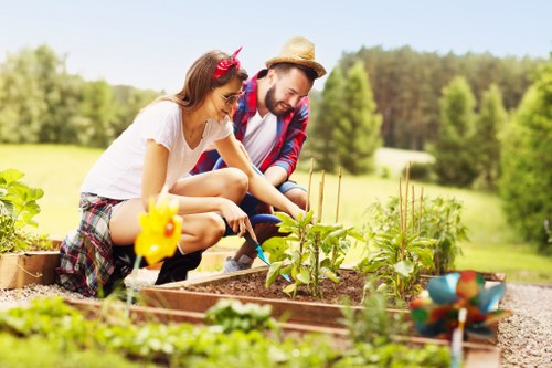 Gardener with tools arriving at a residential garden